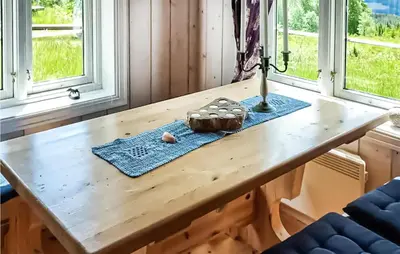 a table in a room with windows and a cupcake at 2 Bedroom Gorgeous Home In Eggedal in Eggedal