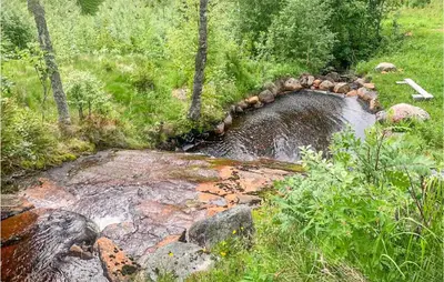 a small stream of water with rocks and trees at 2 Bedroom Gorgeous Home In Eggedal in Eggedal
