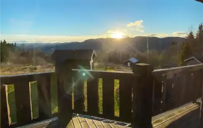 a view from the balcony of a house with the sun setting at 5 Bedroom Gorgeous Home In Eggedal in Eggedal