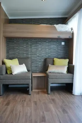 a room with two chairs and a bunk bed at Koie Smart in Stranda