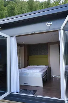a bed in a room with a window at Koie Smart in Stranda