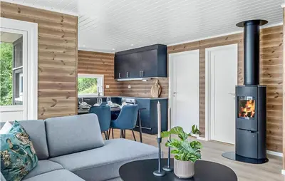 a living room with a couch and a stove at Stunning Home In Gjemnes With Wifi in Stokke