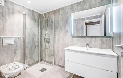 a bathroom with a shower and a toilet and a sink at Stunning Home In Gjemnes With Wifi in Stokke