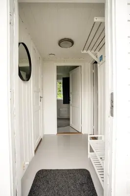 a hallway of a house with a door and a rug at Koie Family in Stranda