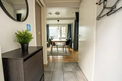 a hallway leading to a dining room with a mirror at Koie Standard in Stranda