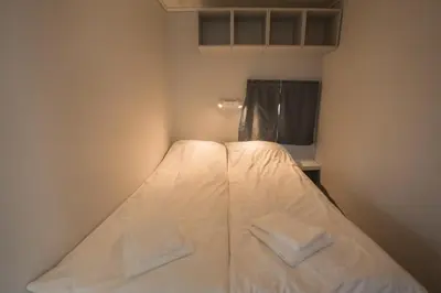 a bed in a small room with two pillows on it at Koie Standard in Stranda