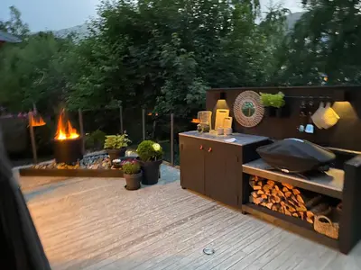 a backyard with a grill and a fire place at Koie Holiday Home 3 in Stranda