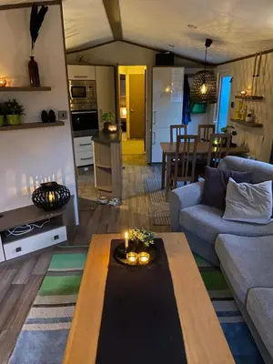 a living room with a couch and a table at Koie Holiday Home 3 in Stranda