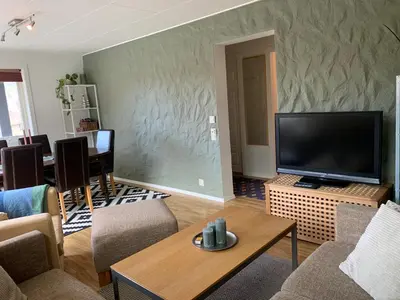a living room with a large flat screen tv at Hemsedal Ulsåk in Torset