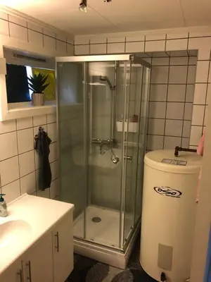 a bathroom with a shower and a toilet and a sink at Hemsedal Ulsåk in Torset