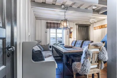 a dining room and kitchen with a table and chairs at Trysilfjellet in Trysil