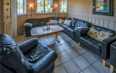 a living room with leather couches and a table at Gorgeous Home In Hemsedal With Sauna in Hemsedal