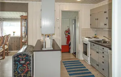 a kitchen with white cabinets and a counter top at 4 Bedroom Nice Home In Vikersund in Vikersund