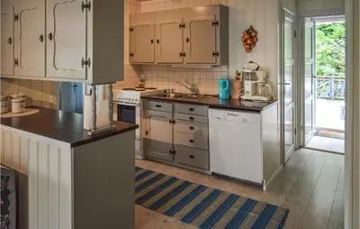 a kitchen with white cabinets and white appliances at 4 Bedroom Nice Home In Vikersund in Vikersund