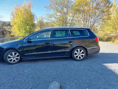 a blue car parked on the side of a road at peaceful place in Hønefoss