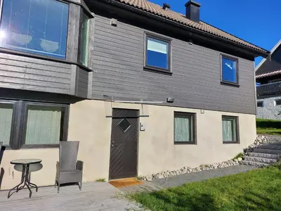 a house with a door and a table in front of it at peaceful place in Hønefoss