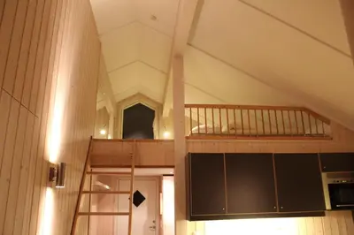 a room with a staircase in a building with a ceiling at Gålå Fjellhytte - cabin with sauna and whirlpool tub in Sør-Fron