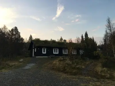 a small house with a grass roof on a field at Gålå Fjellhytte - cabin with sauna and whirlpool tub in Sør-Fron