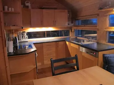 a kitchen with wooden cabinets and a black counter top at Svarthamar - cabin with amazing view in Ål