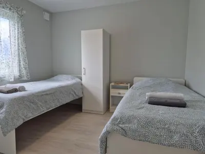 a bedroom with two twin beds and a window at Chausseen Apartments in Krogsti