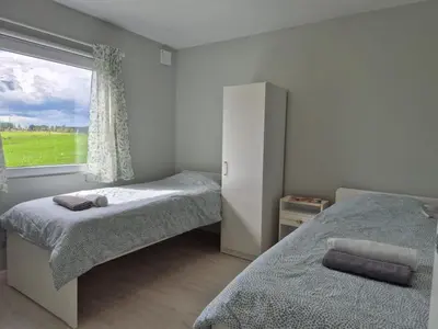 a bedroom with two beds and a window at Chausseen Apartments in Krogsti