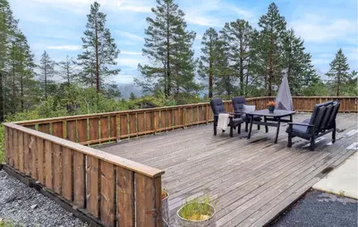 a wooden deck with a table and chairs on it at 4 Bedroom Amazing Home In Stryn in Stryn
