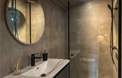a bathroom with a sink and a mirror and a shower at 4 Bedroom Amazing Home In Stryn in Stryn
