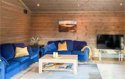 a living room with blue couches and a tv at 4 Bedroom Amazing Home In Stryn in Stryn