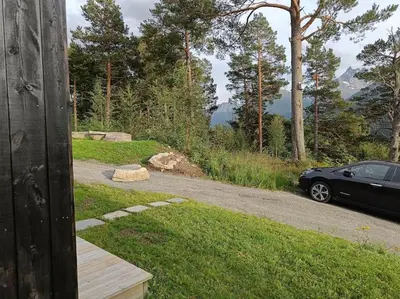 a car parked on the side of a road at Minihuset ved skogen in Isfjorden