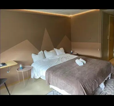 a hotel room with a bed with two towels on it at Gjøvik Overnatting in Gjøvik