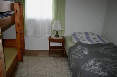 a bedroom with a bed and a lamp on a table at Rekdal in Vestnes