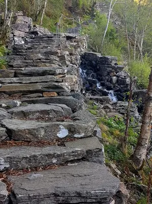 a set of stone stairs next to a river at Rekdal in Vestnes