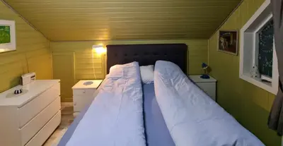 a small bedroom with a bed in a room at Rekdal in Vestnes