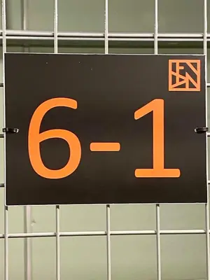 a black and orange sign with the number at New ski in-out apartment with sauna in Hafjell in Øyer