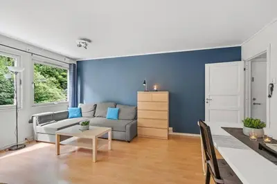 a living room with a couch and a table at Fully equipped independent apartment near NTNU,Lerkendal og center in Trondheim