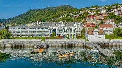 a group of boats in the water in a city at Hofslund Apartments in Sogndal