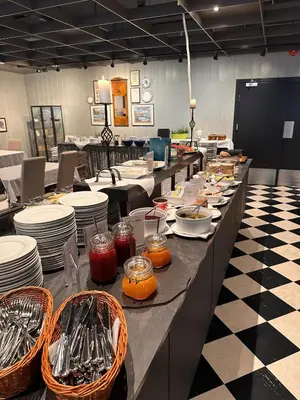 a buffet line with plates and bowls of food at Hofslund Apartments in Sogndal