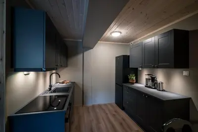 a kitchen with black cabinets and a sink at Bjorli Fjellstuer - by Classic Norway Hotels in Bjorli