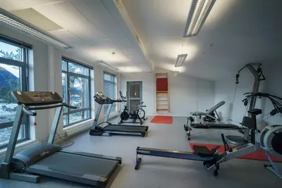 a gym with three treadmills and exercise bikes at Bjorli Fjellstuer - by Classic Norway Hotels in Bjorli