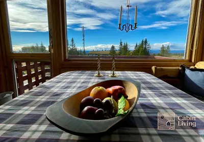a bowl of fruit on a table in front of a window at Cozy apartment with a view and ski inout Hafjell in Hafjell