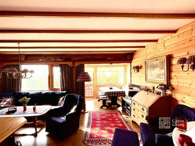 a living room with a couch and a table at Cozy apartment with a view and ski inout Hafjell in Hafjell