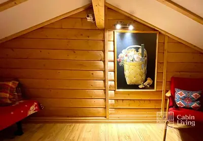 a room with a wooden wall with a picture and a red chair at Cozy apartment with a view and ski inout Hafjell in Hafjell