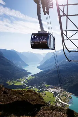 a person is riding a gondola on a mountain at Loen Apartments in Loen