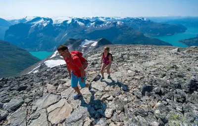 a man and a woman standing on a rocky mountain at Loen Apartments in Loen