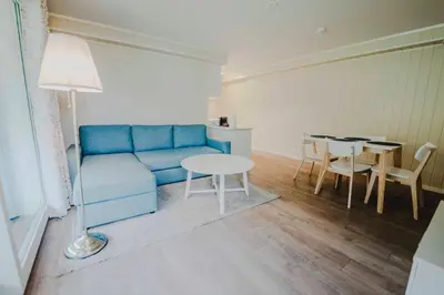 a living room with a blue couch and a table at Loen Apartments in Loen