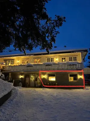 a building with a red fire hose in front of it at Hyggelig leilighet i sentrum in Hemsedal