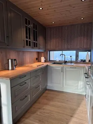 a kitchen with wooden cabinets and a sink and a counter at Aurdalsåsen panorama in Aurdal
