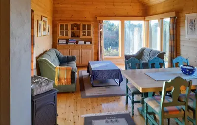 a living room with a table and chairs at 4 Bedroom Stunning Home In Auklandshamn in Tjernagel
