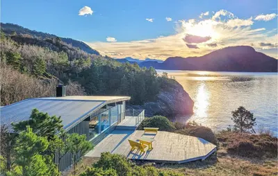 a house on the shore of a body of water at 4 Bedroom Lovely Home In Nordtveitgrend in Hjartåker