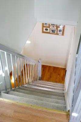a staircase in a house with a stair case at Cosy house with sunny terrace, garden and fjord view in Bergen